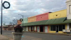 Storefronts with green awnings along a street in the Lake Village Commercial Historic District in Chicot County