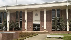 Front of the Ashley County Courthouse in Hamburg, Arkansas, a brick building with white columns and a fountain out front