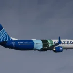A Boeing 737 MAX 10 test plane in United Airlines colors flies during emissions testing in October 2023.