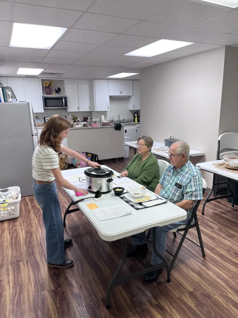 A Kid Chef Challenge participant presents her dish and table setting to a panel of judges at the Bradley County Extension Office.