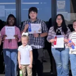 Youth participants in the Bradley County Kid Chef Challenge hold certificates and ribbons outside the Bradley County Extension Office.