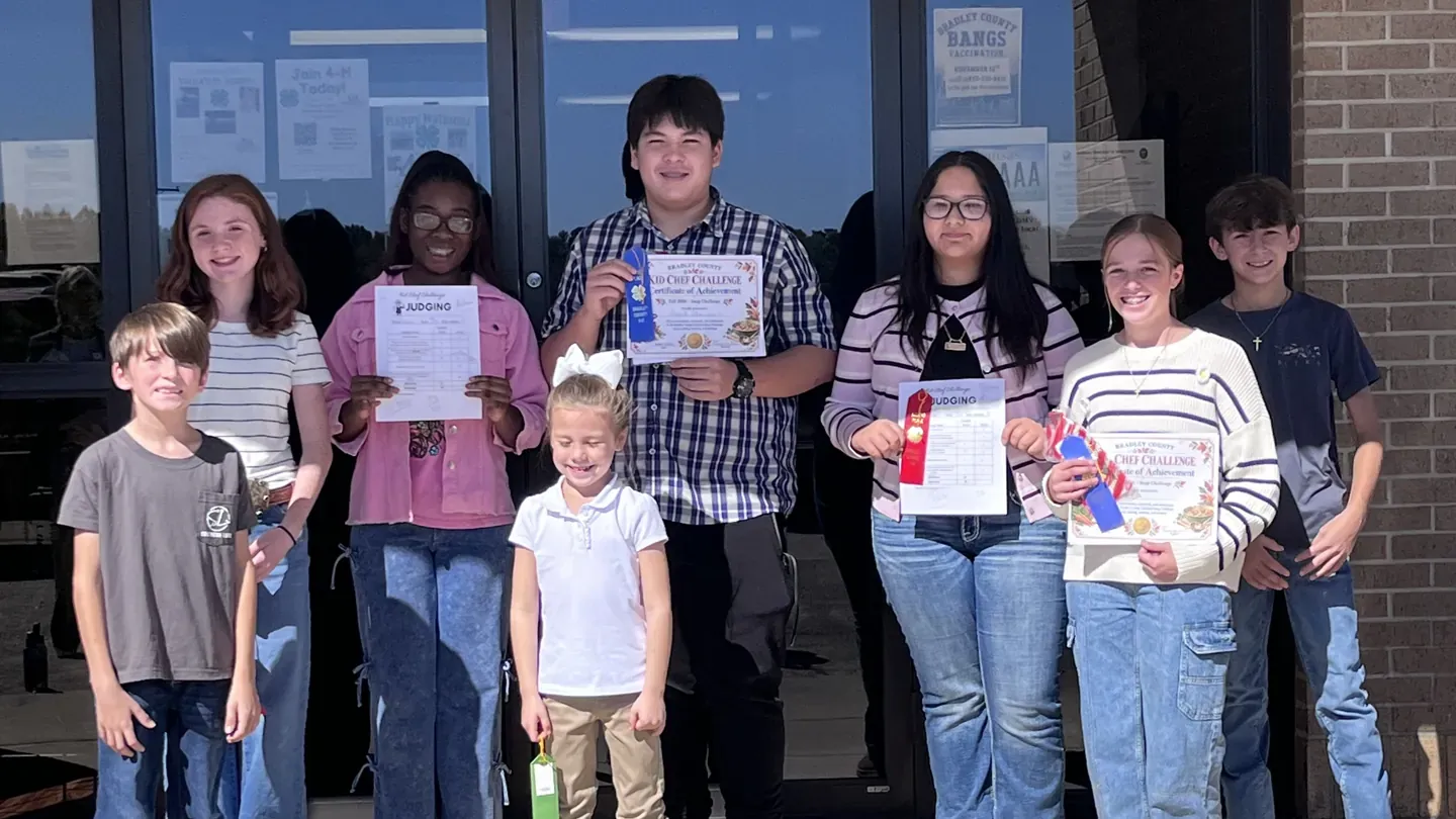 Youth participants in the Bradley County Kid Chef Challenge hold certificates and ribbons outside the Bradley County Extension Office.