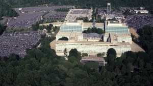 Aerial view of the CIA headquarters buildings in Langley, Virginia, surrounded by parking lots and thick woods.