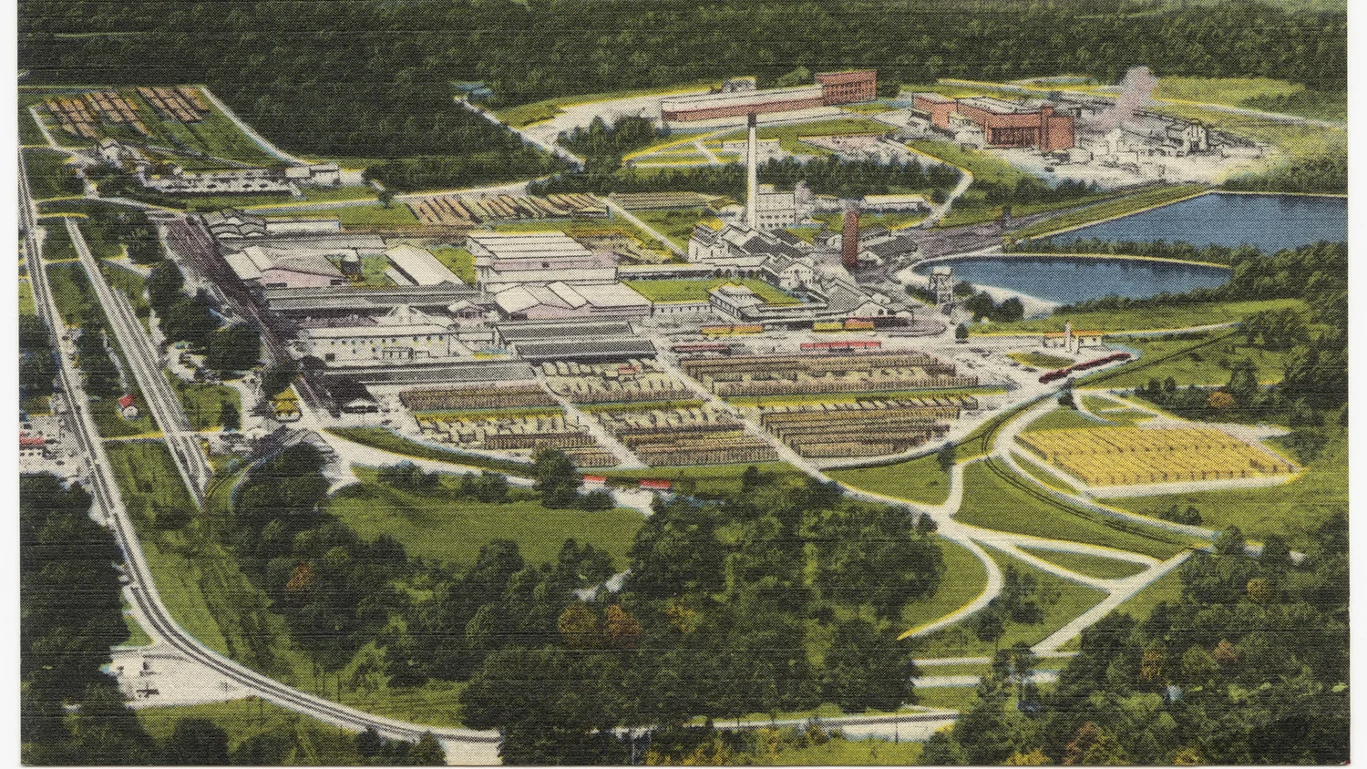 Vintage linen postcard showing an aerial view of Crossett, Arkansas, with mills, lumber yards and surrounding pine forest.