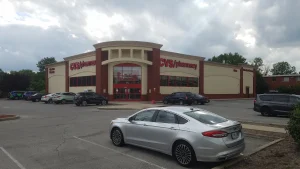 A CVS Pharmacy store with red signs and a parking lot in Beech Grove, Indiana