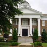 The Dallas County Courthouse in Fordyce, Arkansas, a brick building with a white columned portico and a small dome
