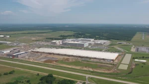 Aerial view of the Google data center campus outside Pryor, Oklahoma, with large white-roofed buildings surrounded by fields and trees.