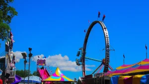 County fair midway with carnival rides and Ferris wheel