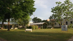 The Drew County Farmers Market pavilion on a shady lawn in Monticello, Arkansas.