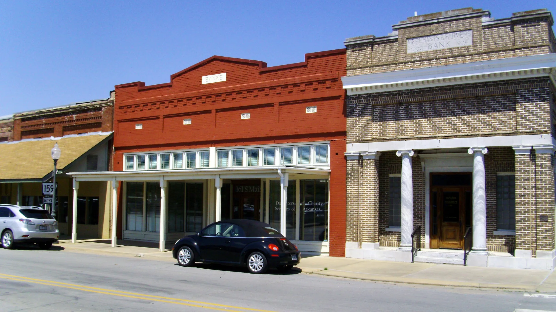 Brick storefronts and a former bank building along Main Street in downtown Dumas.