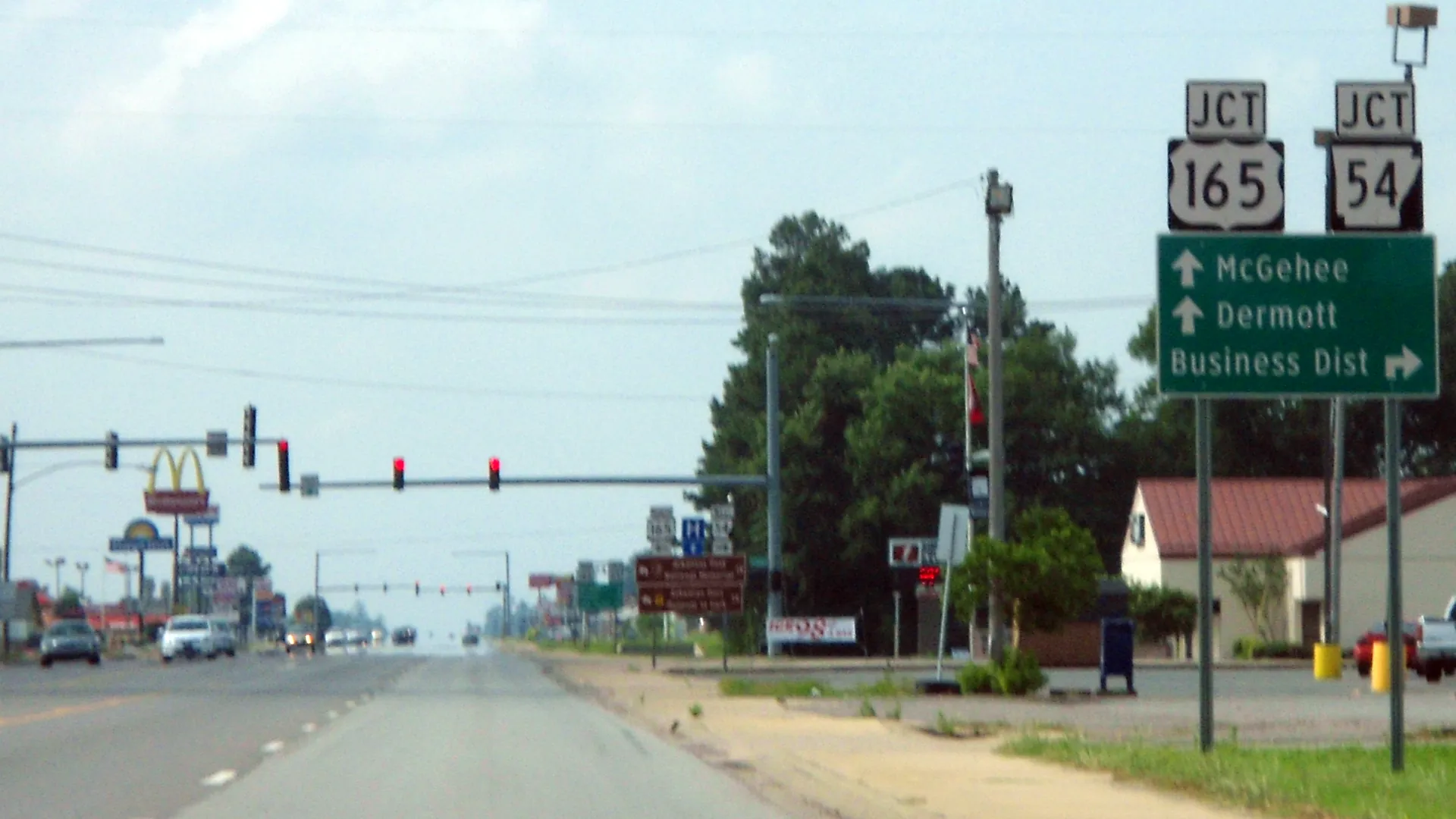 U.S. highways 65 and 165 signs and traffic signals along the highway through Dumas, Arkansas