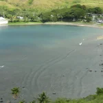 Umatac Bay and the village of Umatac on the southwest coast of Guam, with green hills above the water