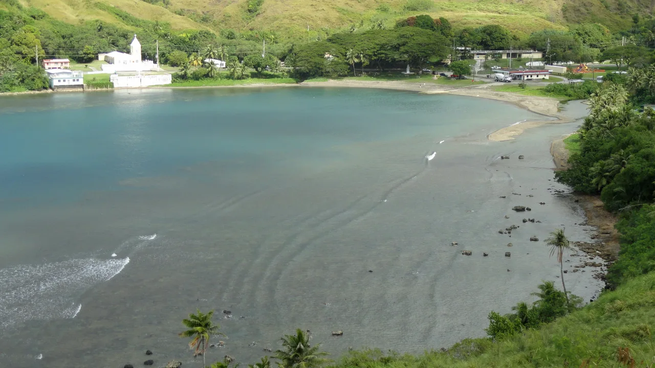 Umatac Bay and the village of Umatac on the southwest coast of Guam, with green hills above the water