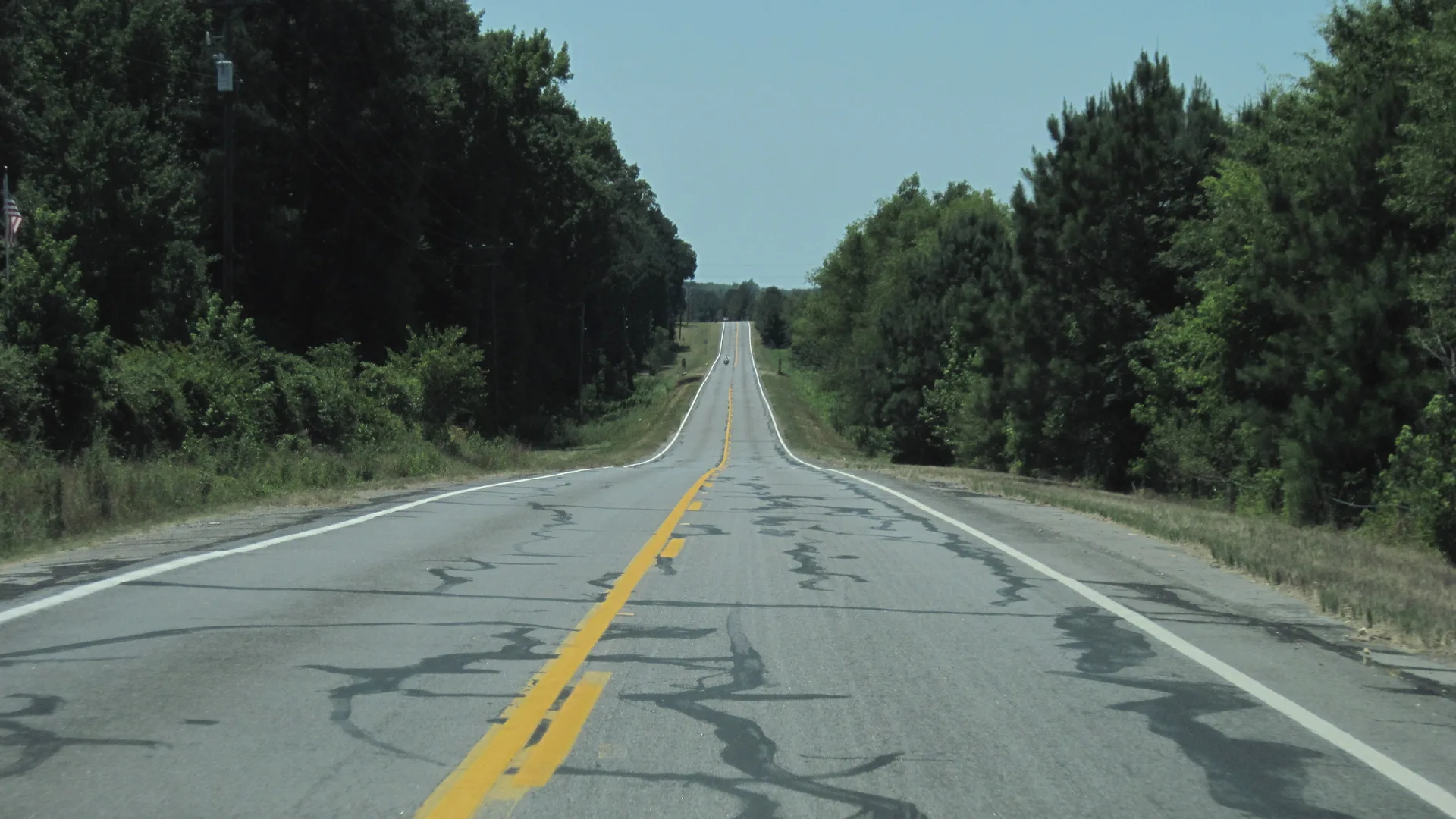 Two-lane Arkansas Highway 365 stretching through pine woods near White Hall in Jefferson County.