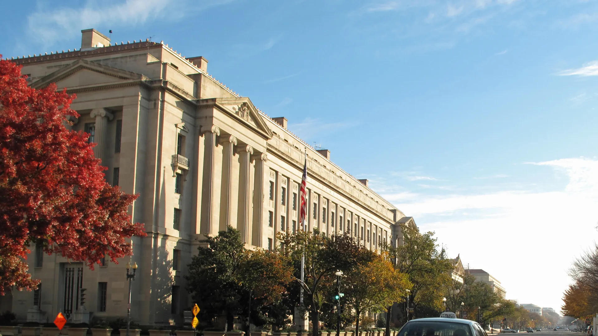 Exterior of the U.S. Department of Justice building on a street in Washington, D.C.
