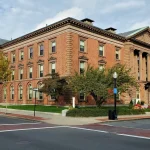 New Bedford City Hall, a red brick building with columns at a downtown intersection in New Bedford, Massachusetts.