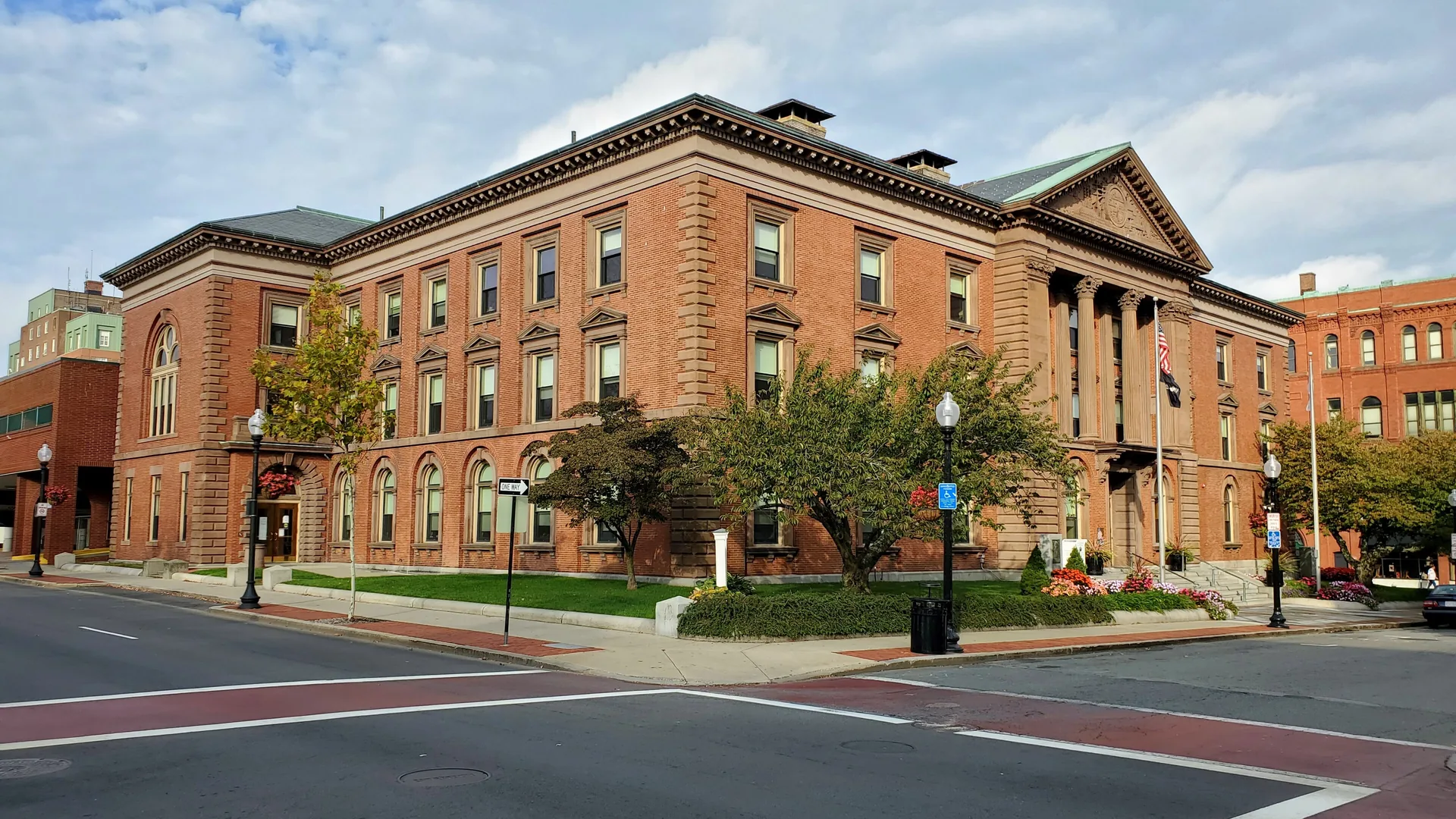 New Bedford City Hall, a red brick building with columns at a downtown intersection in New Bedford, Massachusetts.