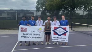 Monticello High School boys tennis players hold a 2026 4A Boys Tennis State Champions banner and a state trophy on a tennis court.