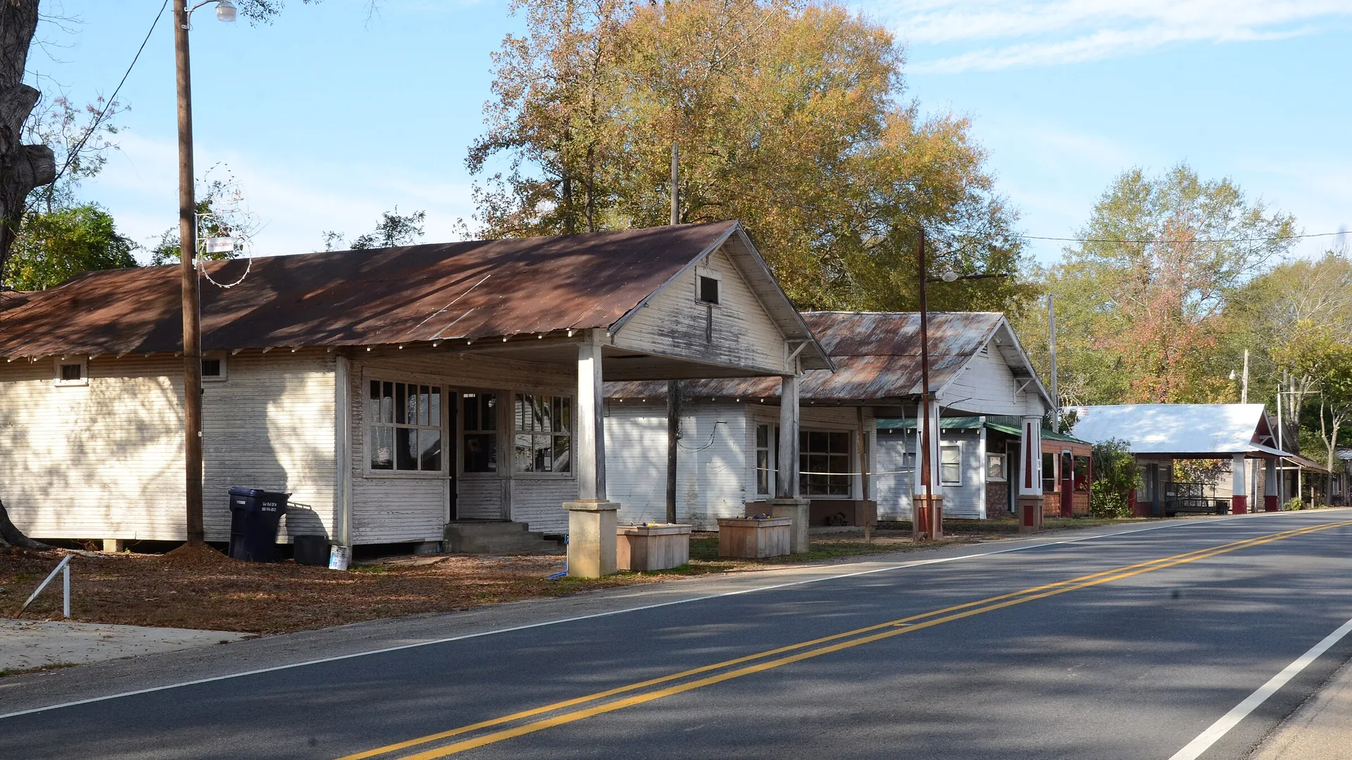 Old wood-frame storefronts with metal roofs along Highway 8 in the New Edinburg Commercial Historic District
