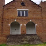 New Zion AME Church, a red-brick church with twin crenellated towers, in Warren, Arkansas.
