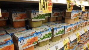 Two multipacks of Gerber baby food jars on a store shelf