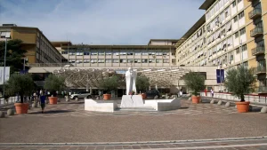 Front entrance of Agostino Gemelli University Hospital in Rome with the marble statue of Pope John Paul II in the plaza