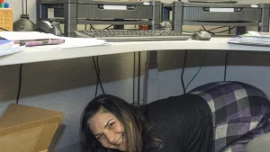 People practice Drop, Cover and Hold On during an earthquake drill
