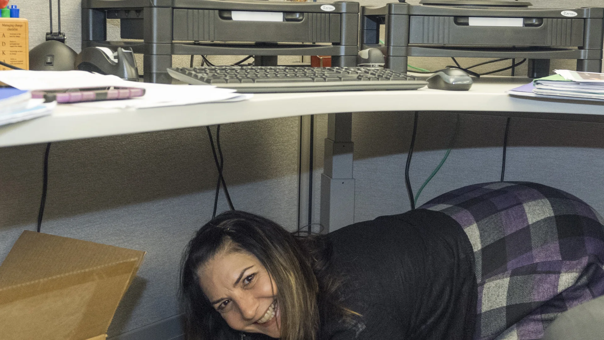 People practice Drop, Cover and Hold On during an earthquake drill