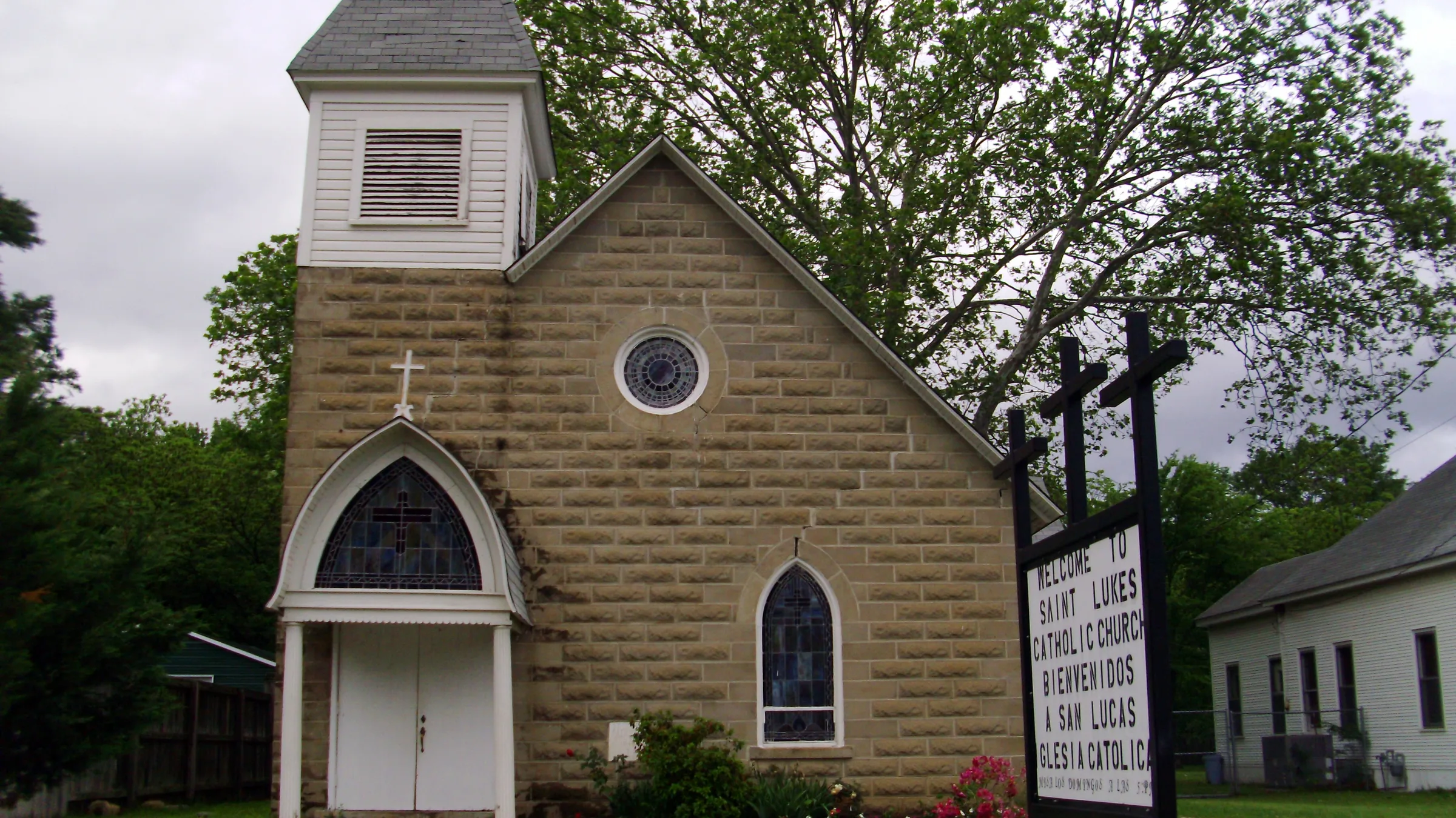 St. Luke's Catholic Church, a stone church with a white steeple, in Warren, Arkansas.