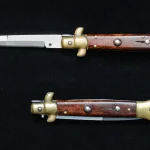 An Italian-style stiletto switchblade knife shown open and closed on a black background.