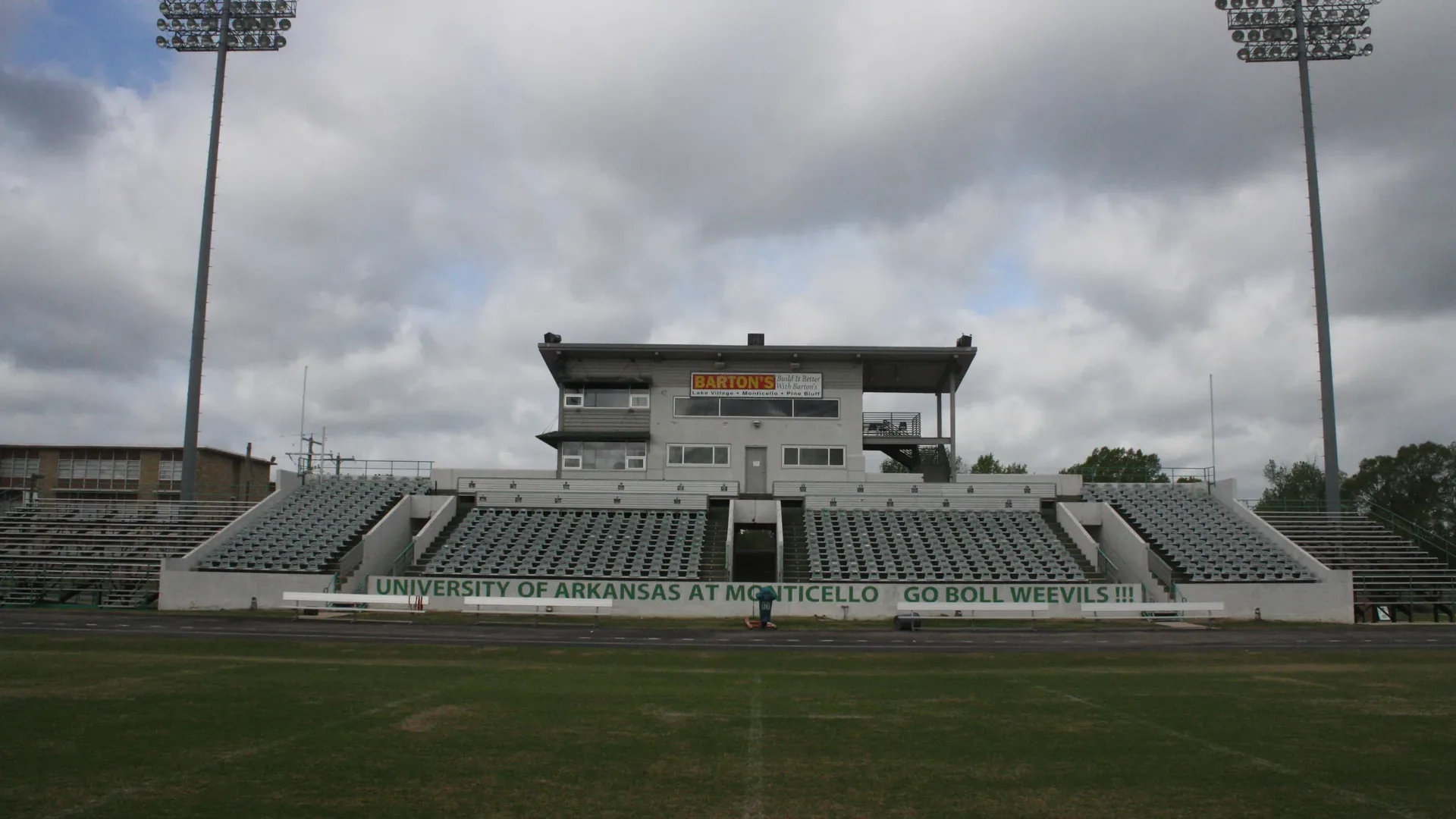 Grandstand and press box at Cotton Boll Stadium at UAM in Monticello with Go Boll Weevils sign