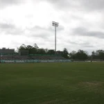 The empty field and home grandstand at Willis "Convoy" Leslie Cotton Boll Stadium on the UAM campus in Monticello under a cloudy sky