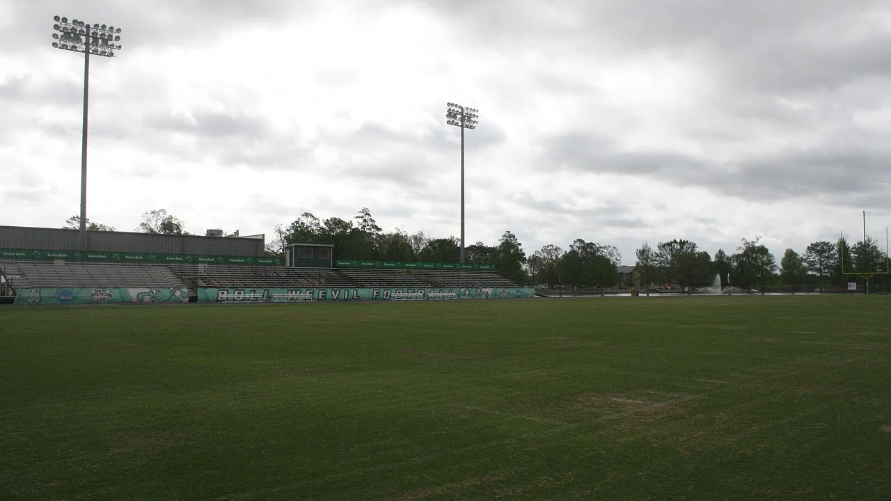 The empty field and home grandstand at Willis "Convoy" Leslie Cotton Boll Stadium on the UAM campus in Monticello under a cloudy sky
