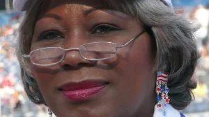Close-up portrait of Virginia state Sen. Louise Lucas wearing glasses and flag earrings at the 2008 Democratic National Convention in Denver.