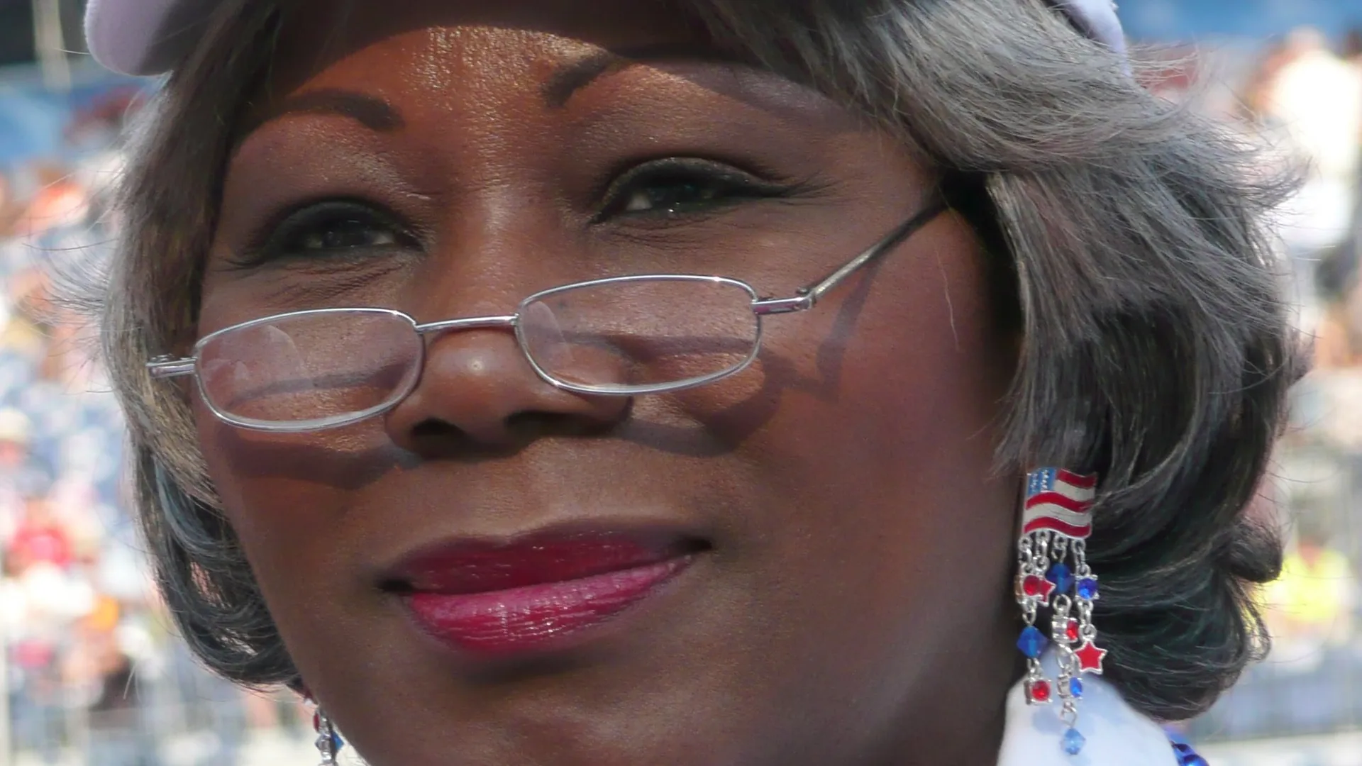 Close-up portrait of Virginia state Sen. Louise Lucas wearing glasses and flag earrings at the 2008 Democratic National Convention in Denver.