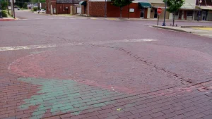 Brick street in downtown Warren, Arkansas, with a pink tomato festival marker