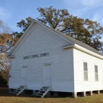 Wesley Chapel, a small white frame church with a gabled roof, in Woodlawn in Cleveland County, Arkansas.
