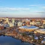 Aerial view of downtown Wichita, Kansas, along the Arkansas River, including the domed Century II convention center