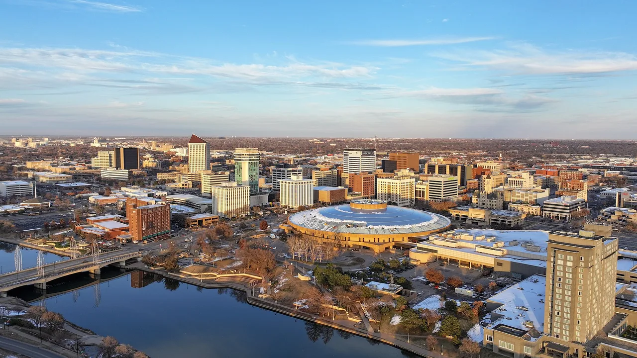 Aerial view of downtown Wichita, Kansas, along the Arkansas River, including the domed Century II convention center