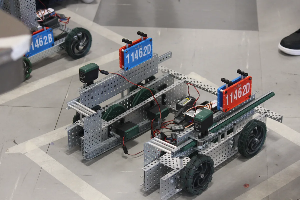 Student-built VEX Robotics Competition robots on a competition floor