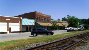 Downtown Dumas, Arkansas, with brick storefronts beyond the railroad tracks in the foreground.