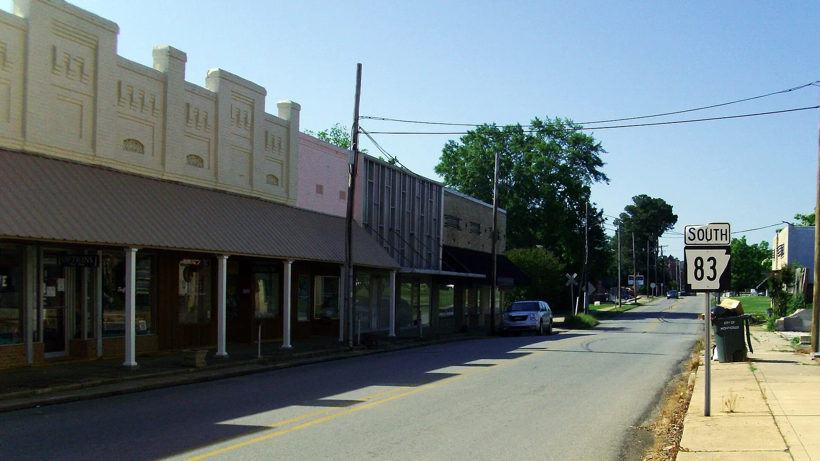 Highway 83 through the Monticello Commercial Historic District in downtown Monticello, Arkansas, with brick commercial buildings along the street.