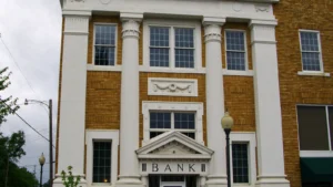 An ornate two-story white building with a decorative roofline in downtown Warren, Arkansas.