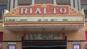 The front of the Rialto Theater in downtown El Dorado, Arkansas, with its red and yellow neon marquee reading RIALTO.