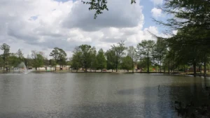 Weevil Pond with its fountain and surrounding trees on the University of Arkansas at Monticello campus.