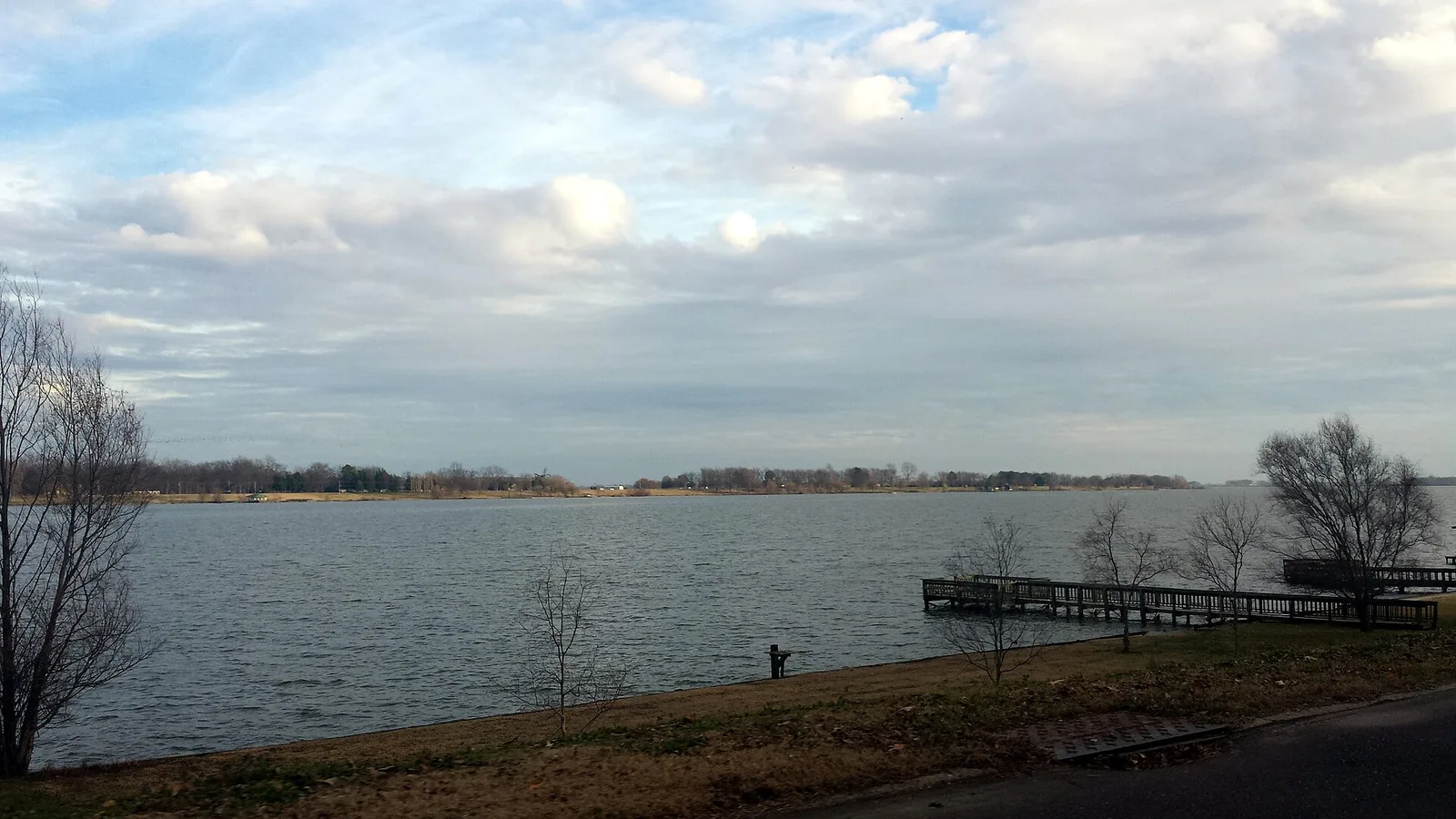 Lake Chicot seen from Lakeshore Drive in Lake Village, Arkansas, with a small wooden pier.