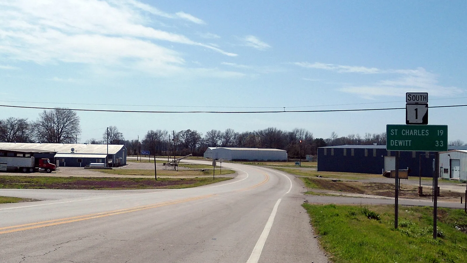 Highway 1 approaching a cluster of buildings in Marvell, Arkansas.