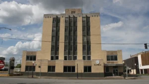 The former Pine Bluff School District Administrative Center, a tall narrow Art Deco-style building of yellow-brown brick.