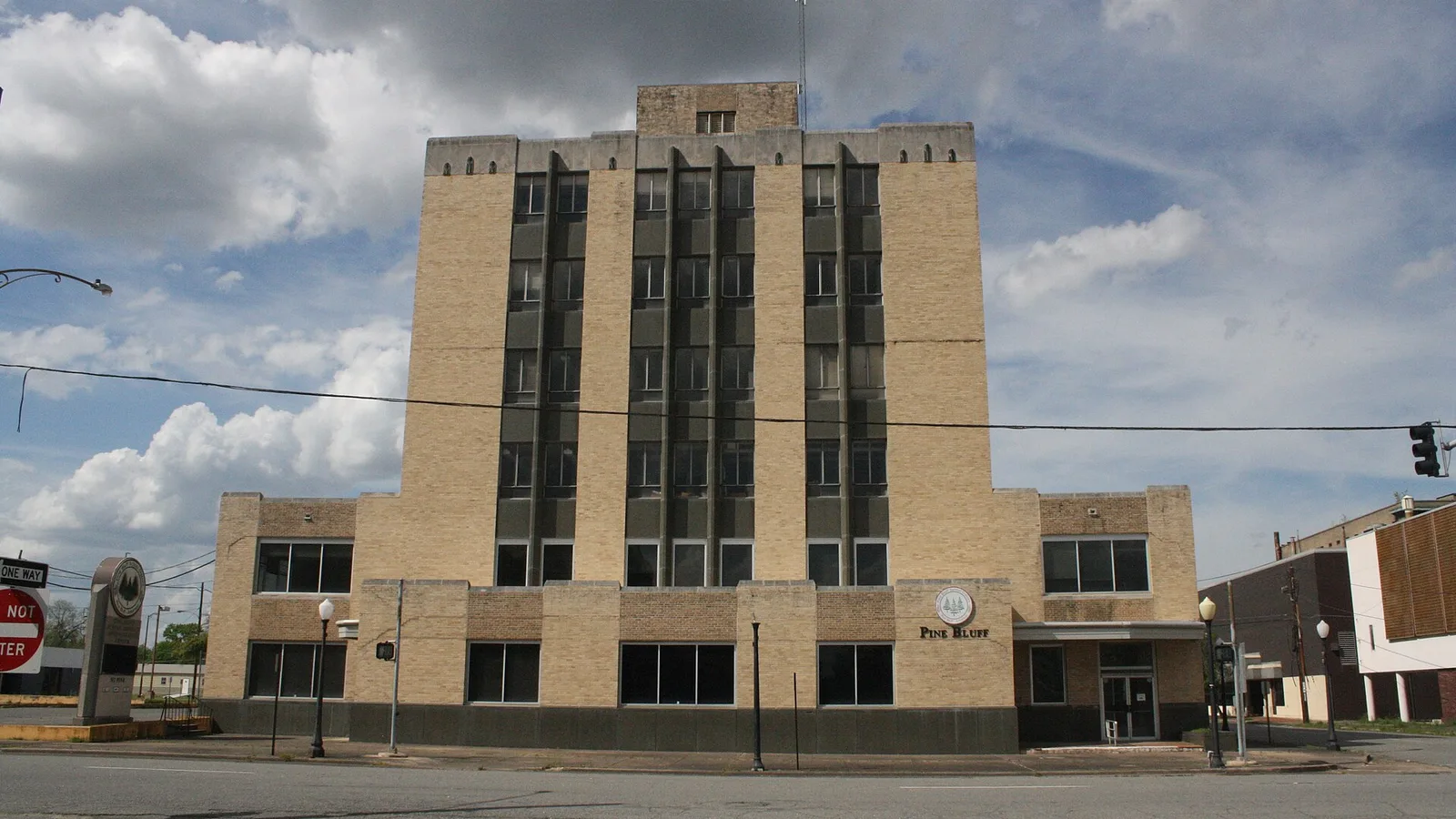 The former Pine Bluff School District Administrative Center, a tall narrow Art Deco-style building of yellow-brown brick.
