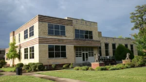 The John Brown Watson Memorial Library at the University of Arkansas at Pine Bluff, a three-story light-brick building with vertical window bands.